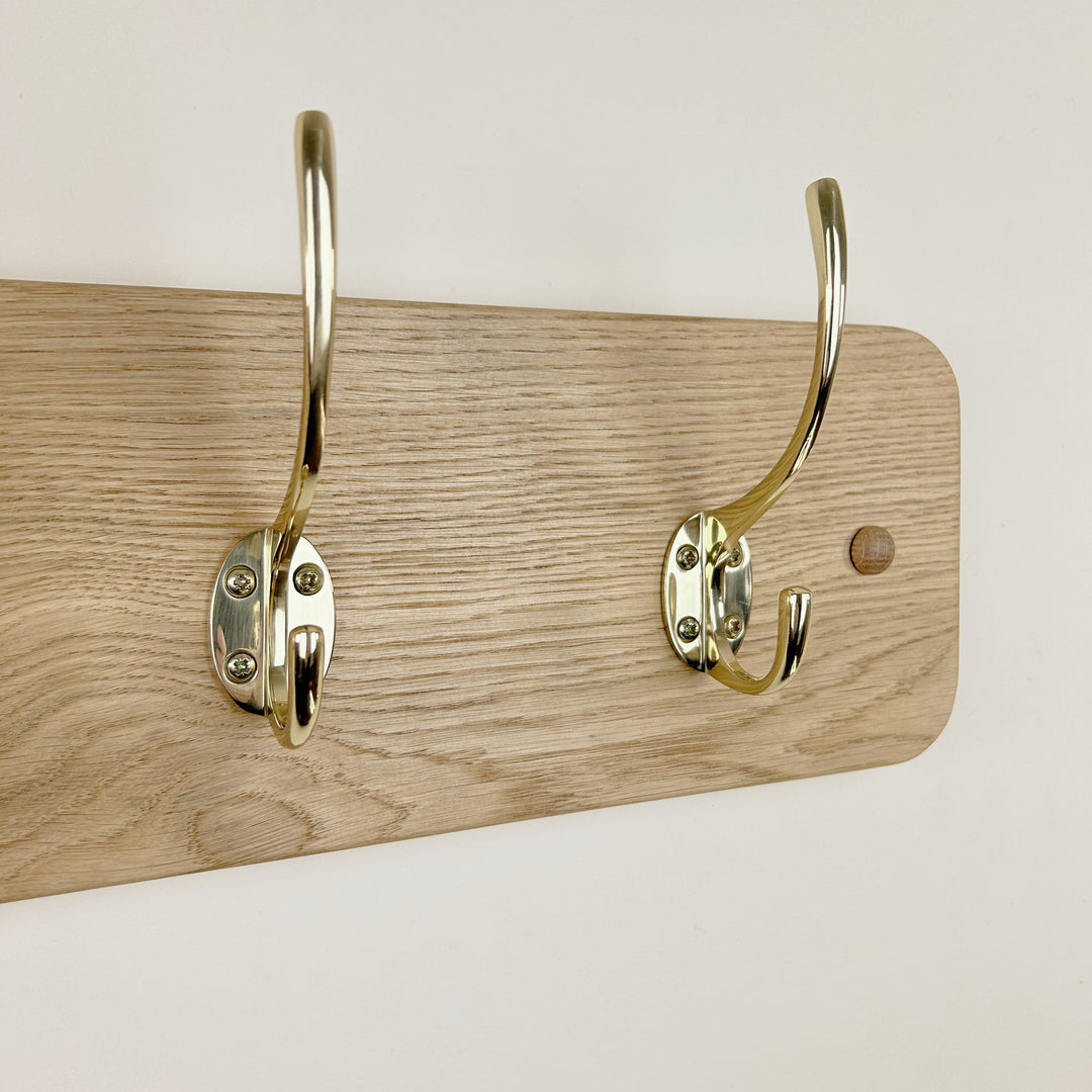 Curved solid oak coat rack - polished brass hooks