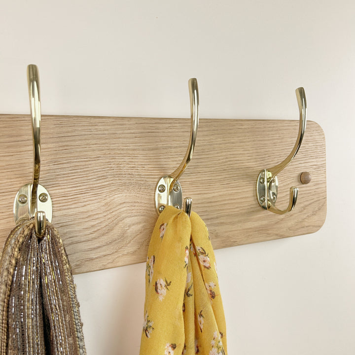 Curved solid oak coat rack - polished brass hooks